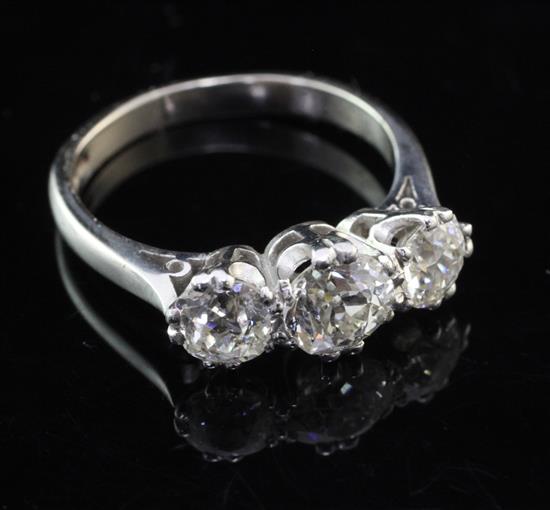 A modern 18ct white and three stone diamond ring, size O.